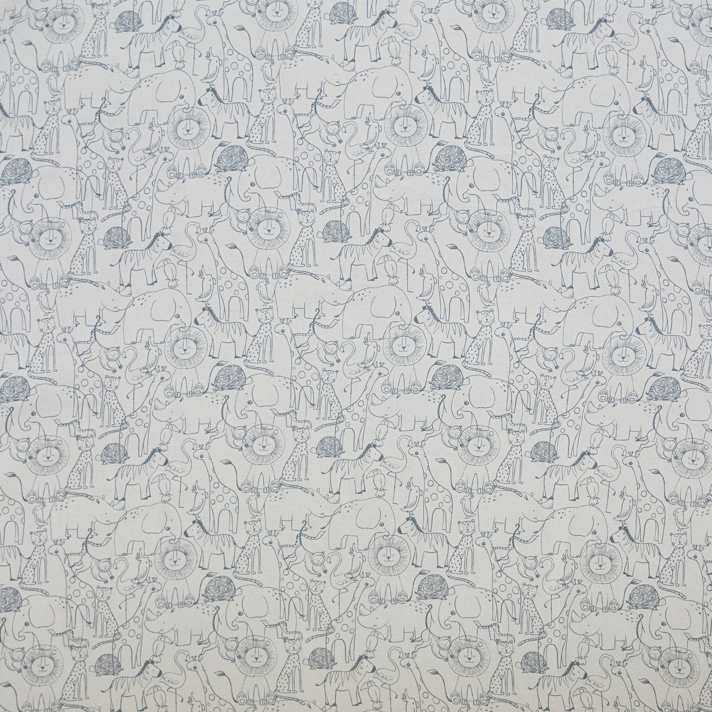 Flat lay of curtain fabric with a soft woven texture and delicate animal pattern