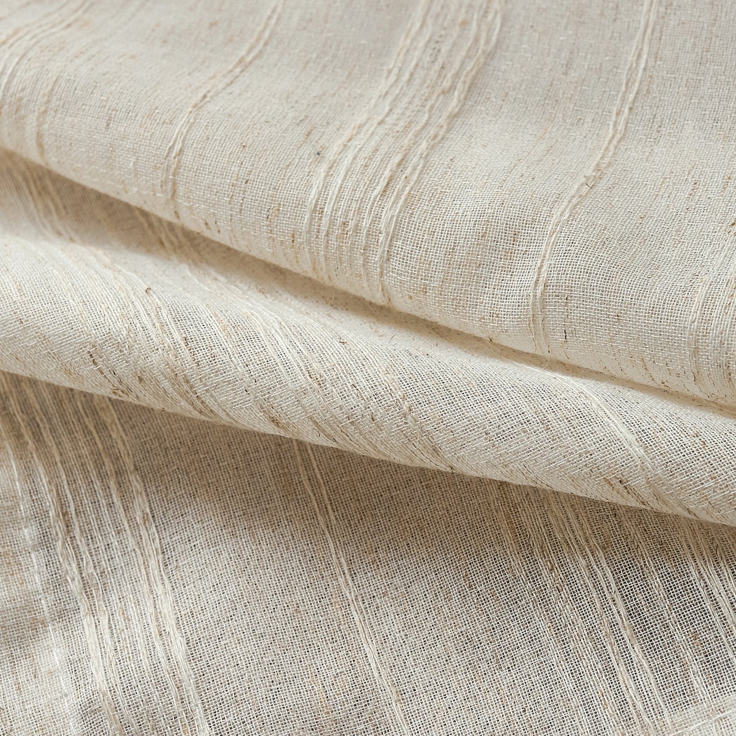 Fabric detail of farmhouse ivory curtains, soft linen decorated with organic woodgrain lines for farmhouse appeal.