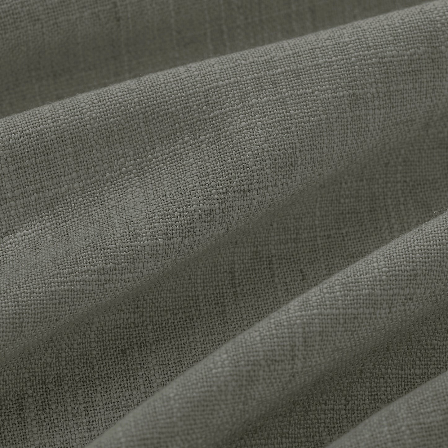 Detail of textured pale gray polyester-linen woven curtains.