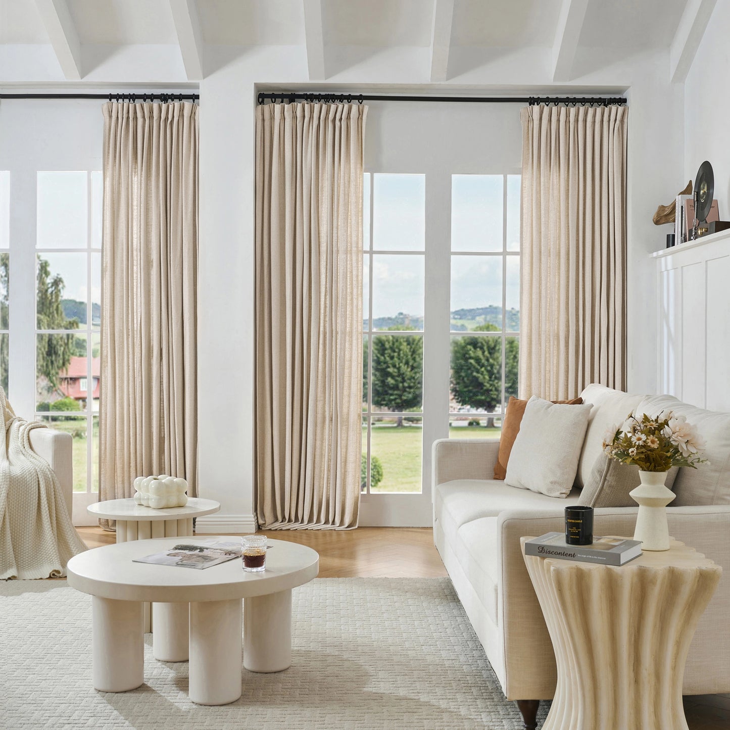 Modern living room with natural woven poly-viscose-linen curtains, sofa, and tables.