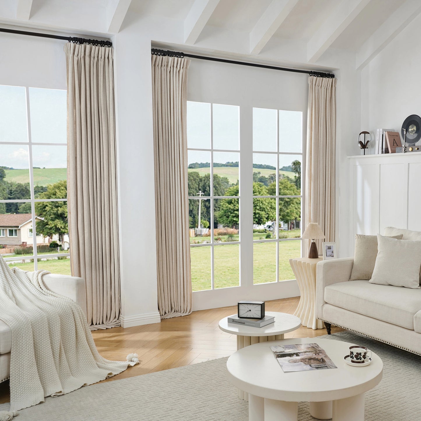 Living room with large windows, sand-poly-viscose-linen-drapery, and a white sofa.