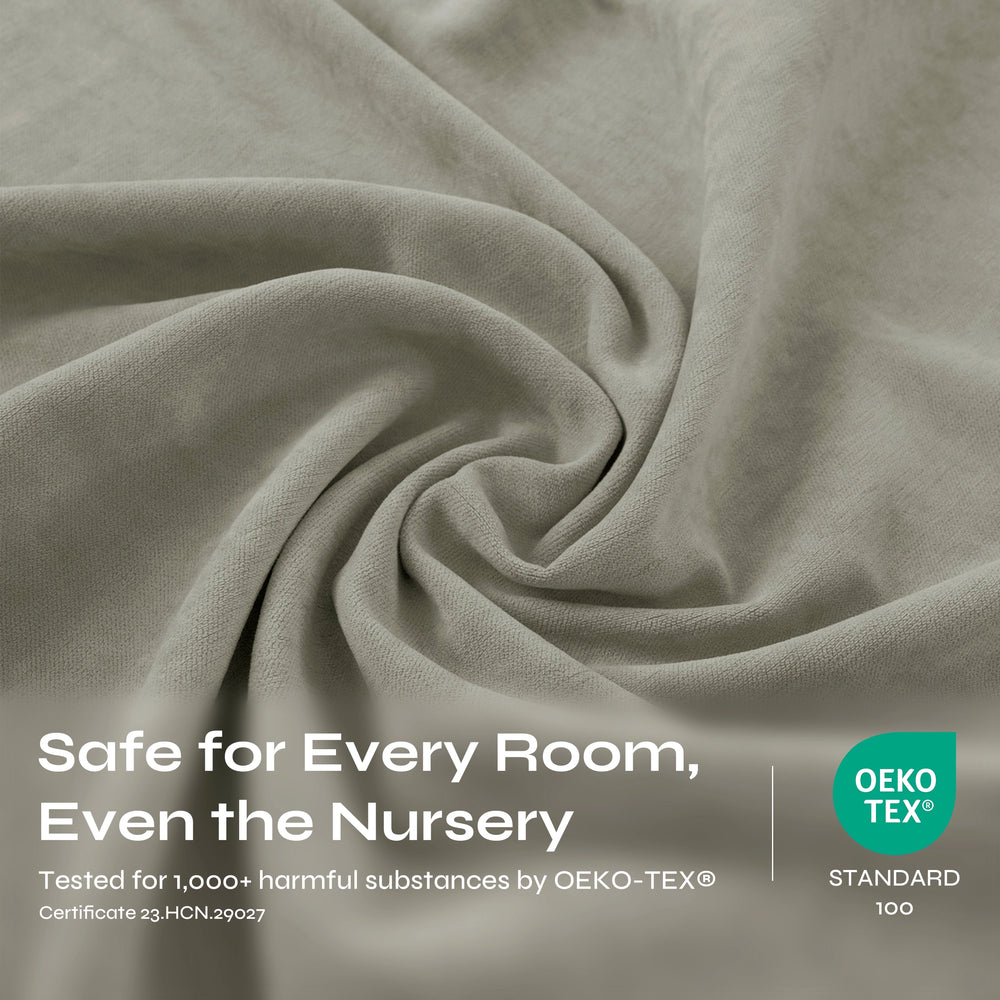 A close-up of draped light gray fabric with a soft, textured weave and gentle folds.