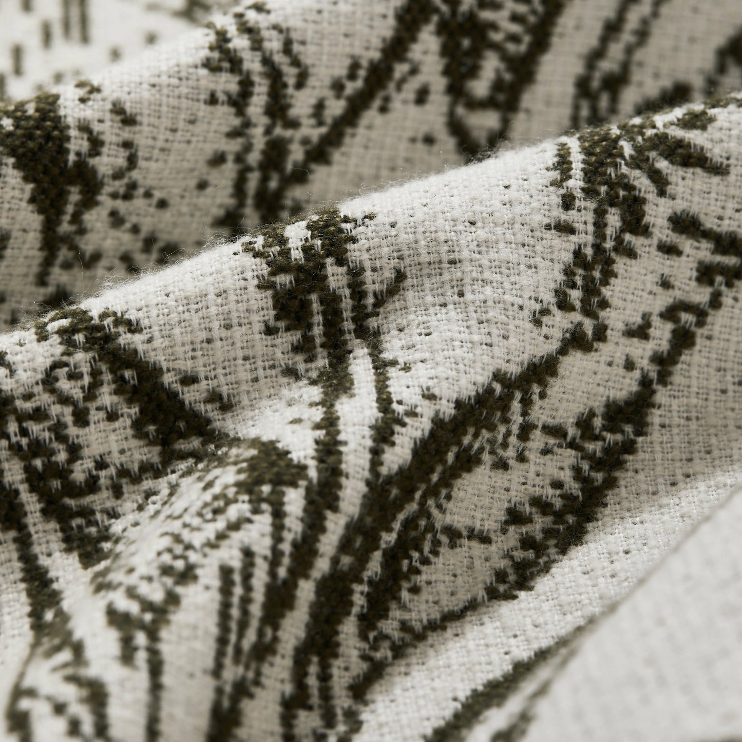 Detailed view of boho leafy line pattern curtains in olive shades, fabric weave showing cozy warmth and chic natural appeal.