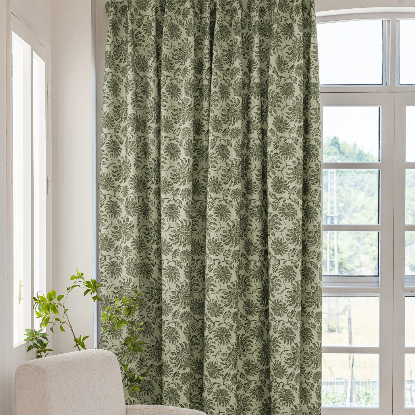Botanical leaf curtains hanging by the window, softly filtering natural light