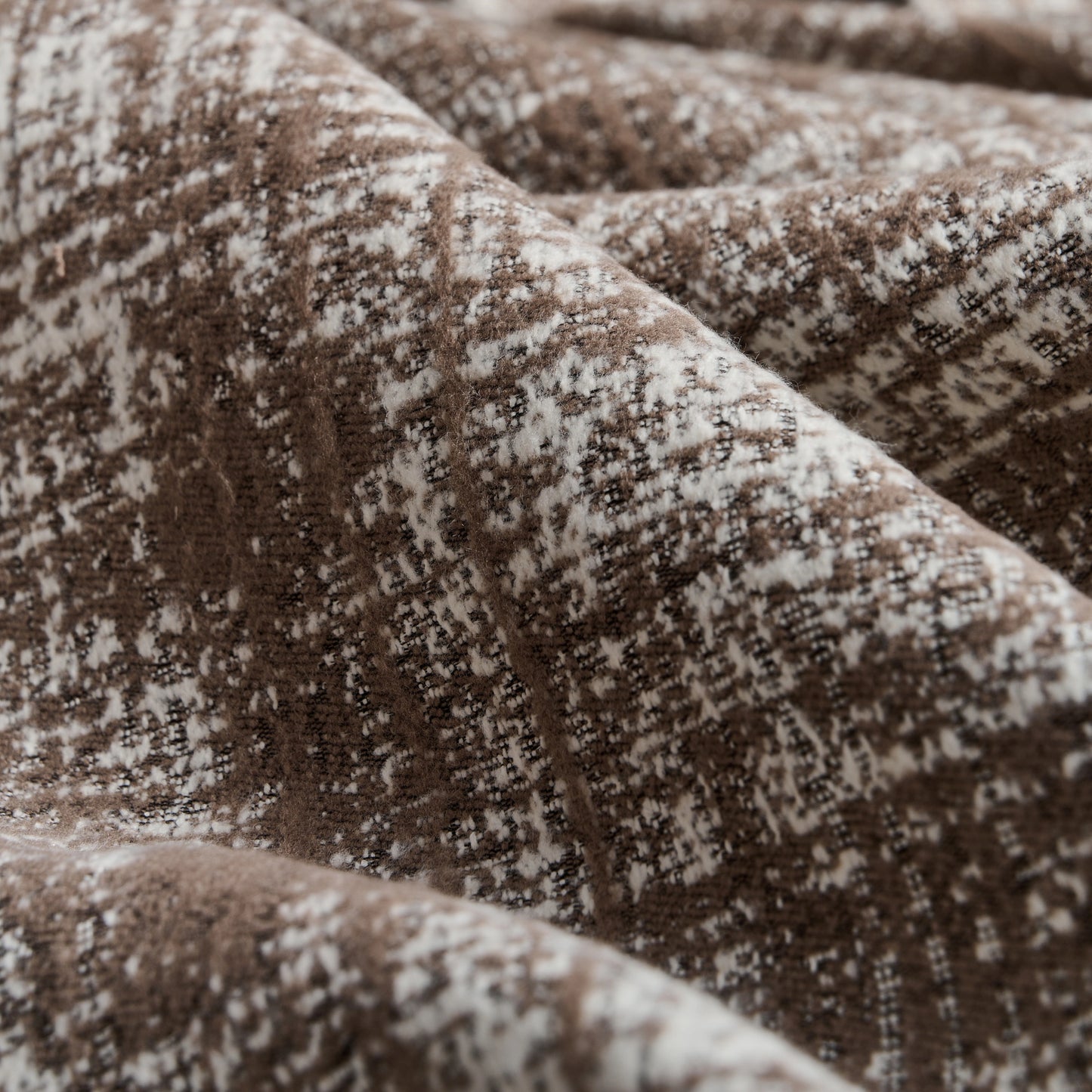 Detail of taupe curtain fabric featuring brushed plaid texture, with a detailed weave adding depth and decorative refinement.