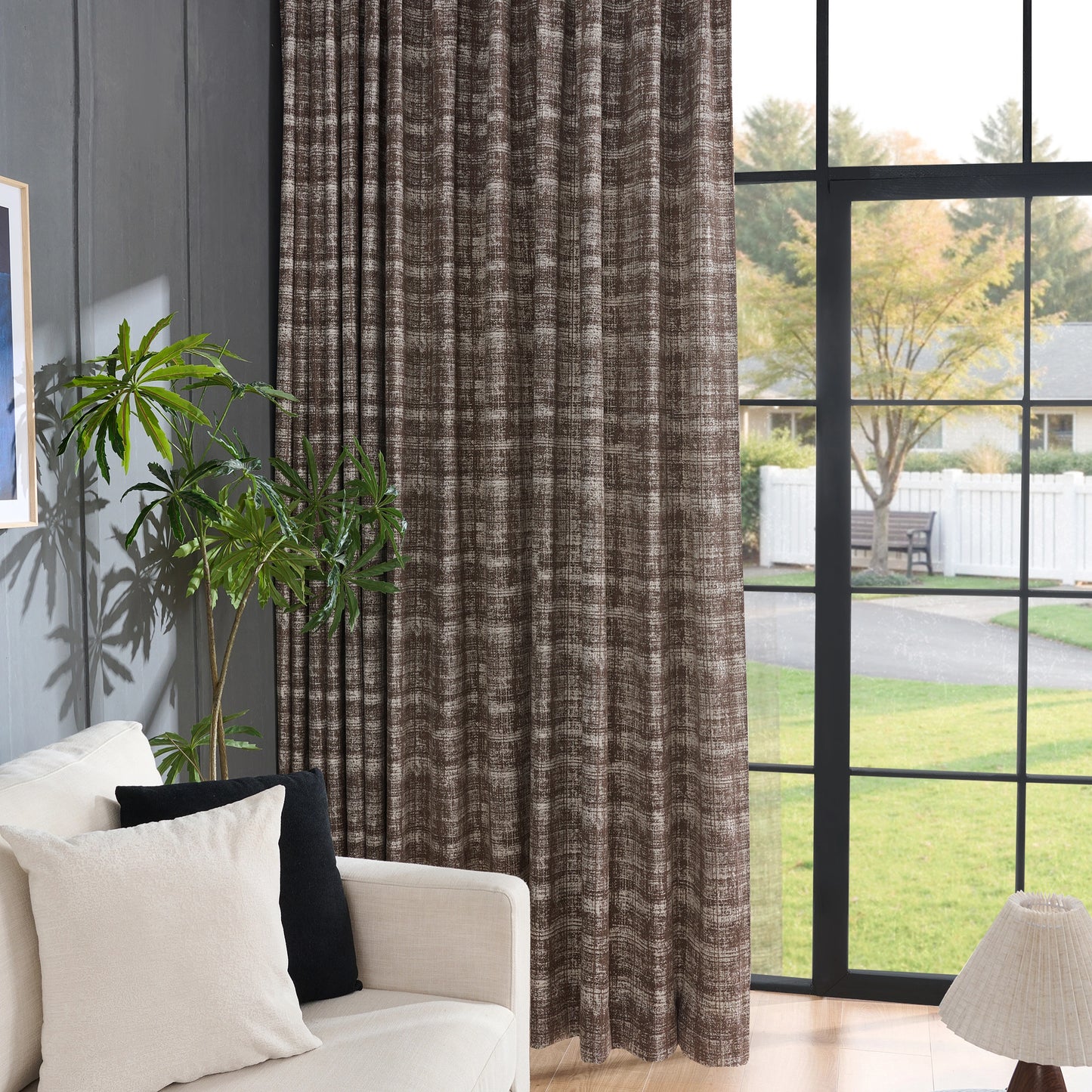Living room with chocolate curtains showing textured crosshatch design, a white sofa, and a large window.