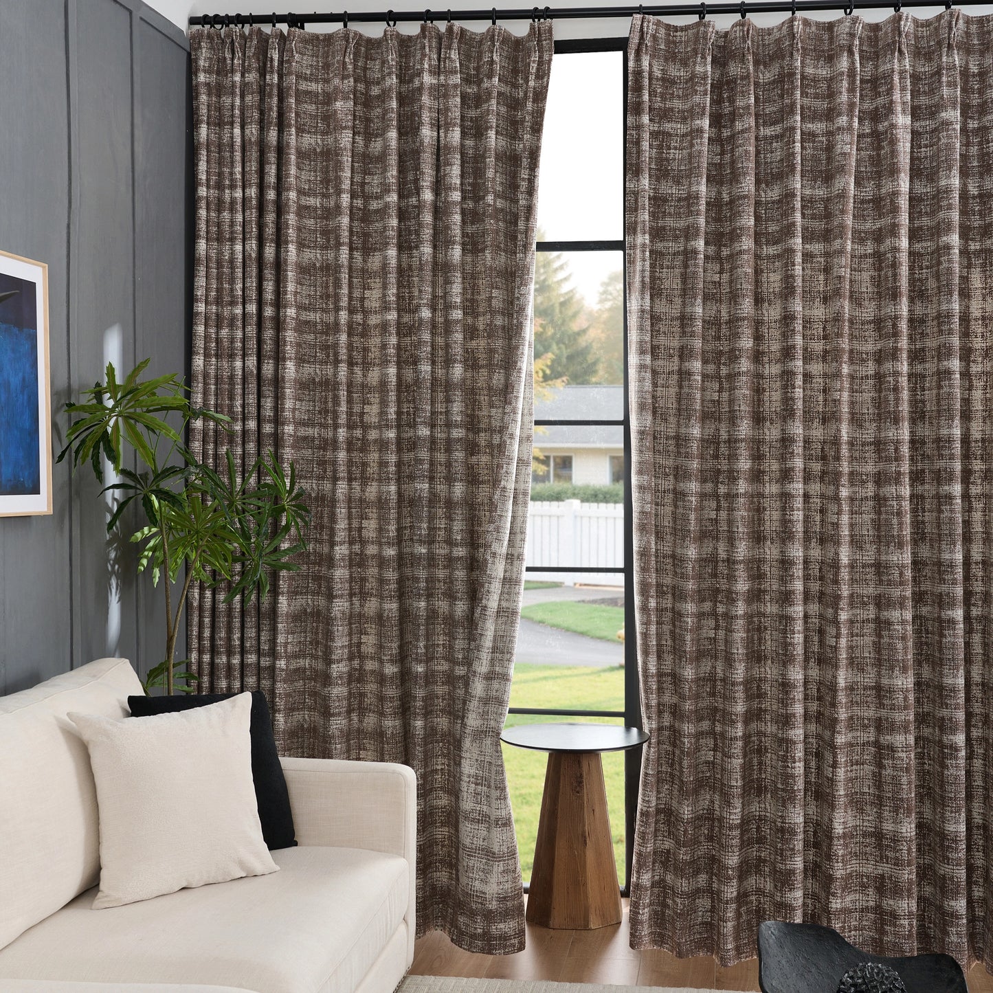 Cocoa modern curtains in brushed plaid texture, sleek drapery panels in a living room with a couch and plant.