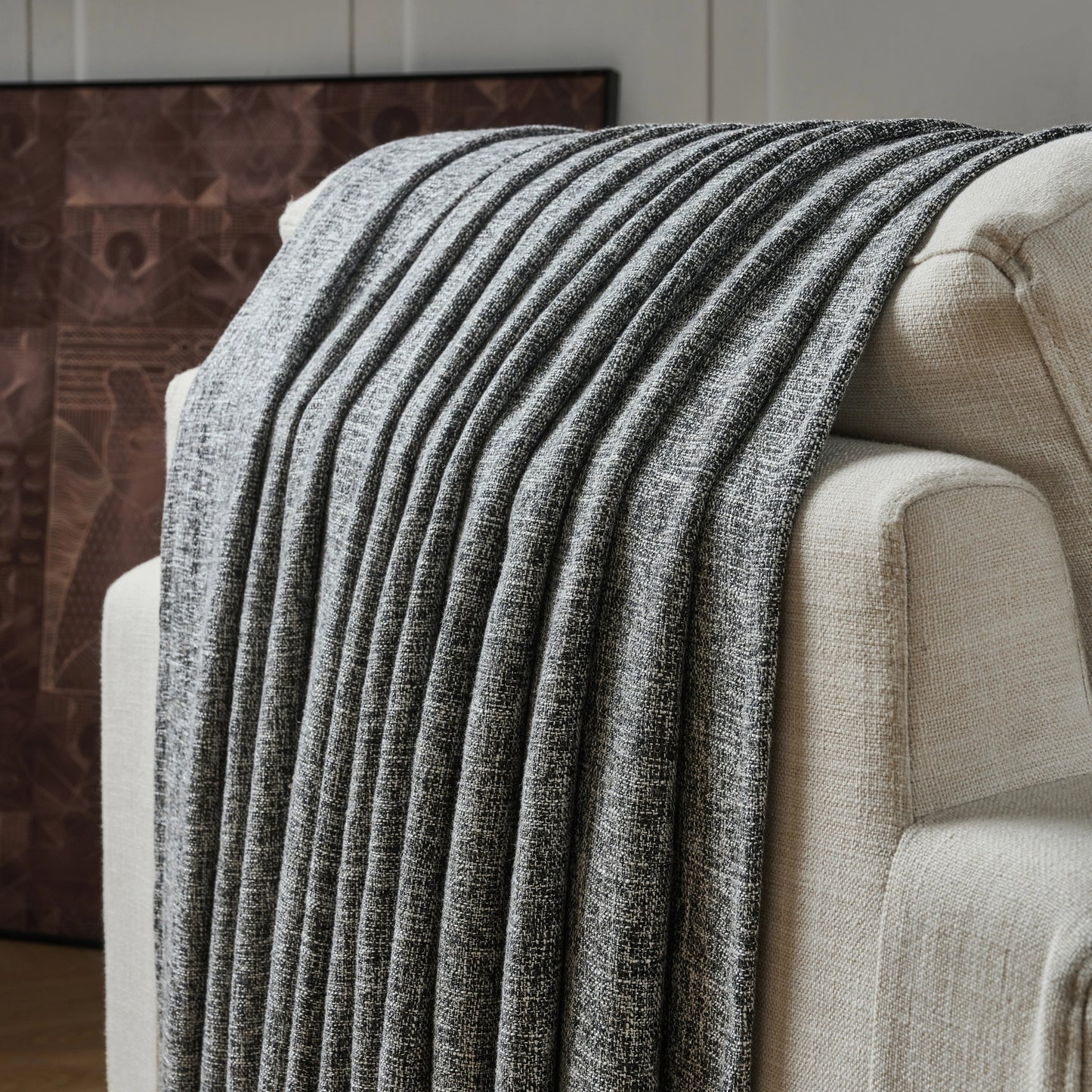 Gray mixed with white poly viscose linen curtain panel draped over a chair with a neutral background.