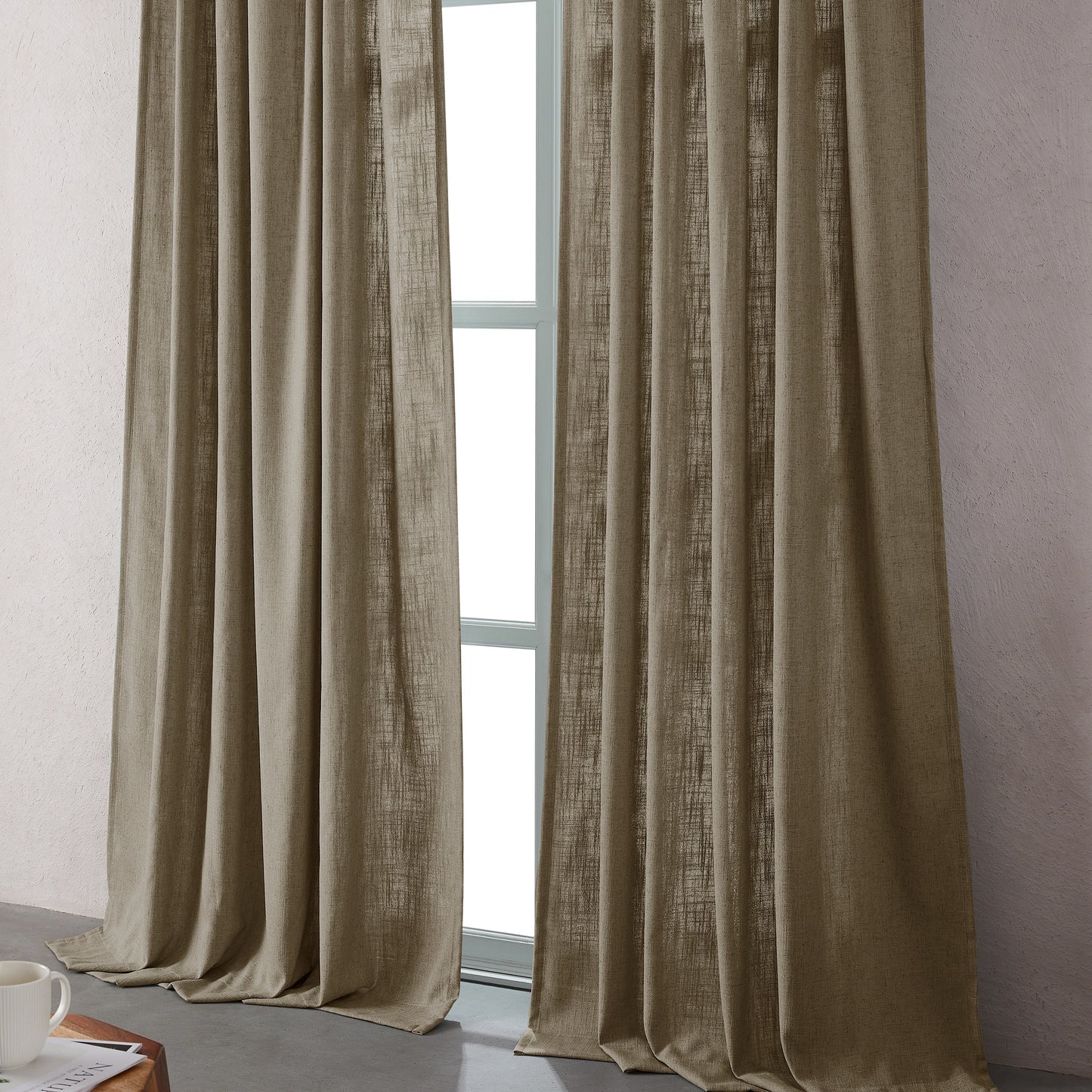 Camel linen-polyester blend curtains hanging in front of a window with a neutral background.