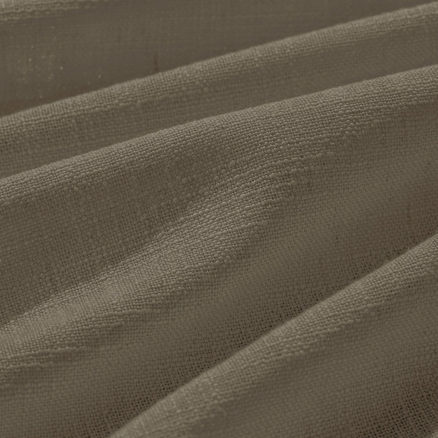 Detail of textured camel polyester-linen woven curtains.