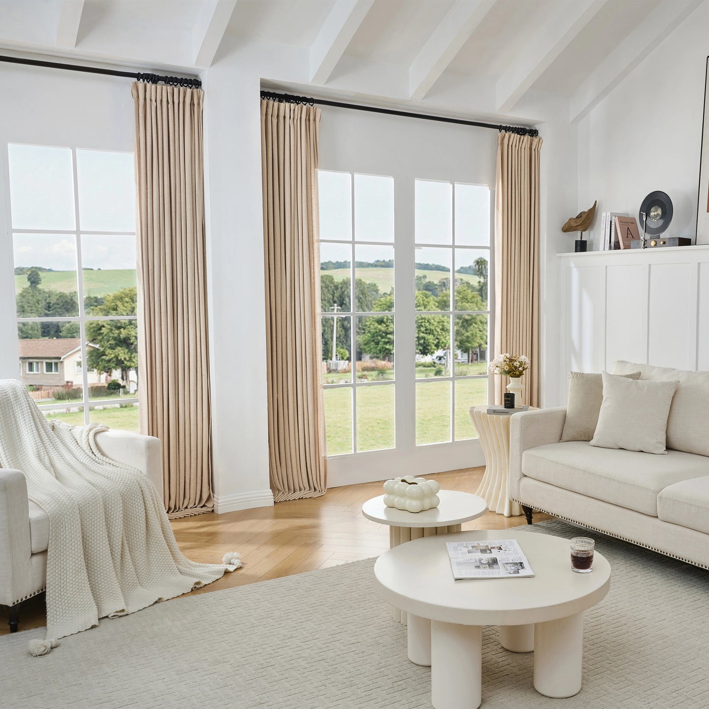 Living room with camel-toned viscose, polyester, and linen mixed fabric curtain, white sofa, and tables.