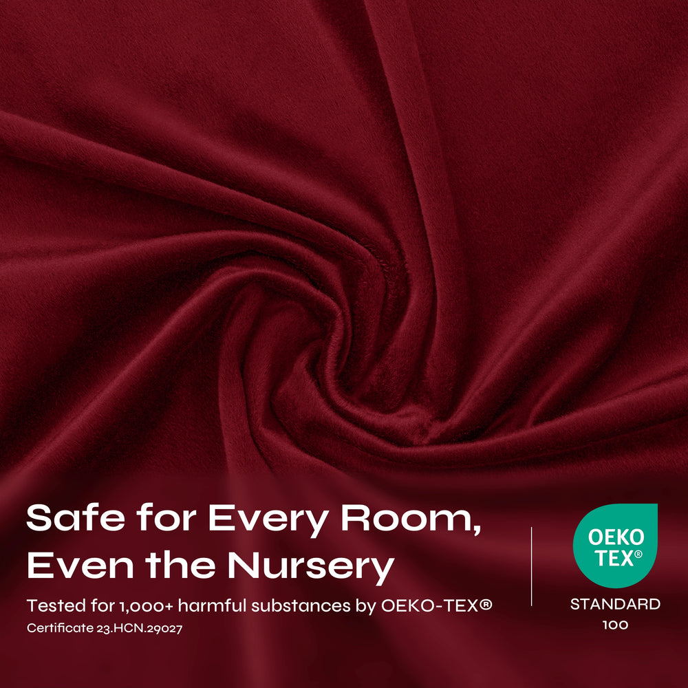 Deep burgundy velvet fabric draped in a central spiral pattern, showcasing its soft, plush texture and rich color.