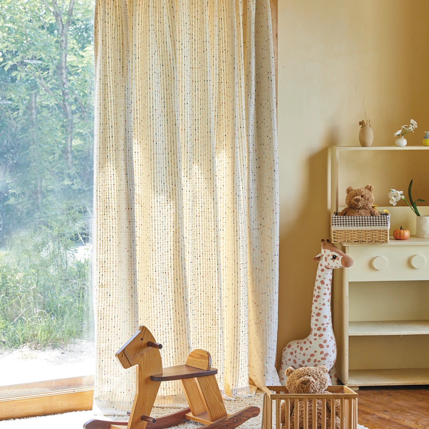 Cozy curtains filtering daylight in a nursery, adding warmth and a soft atmosphere