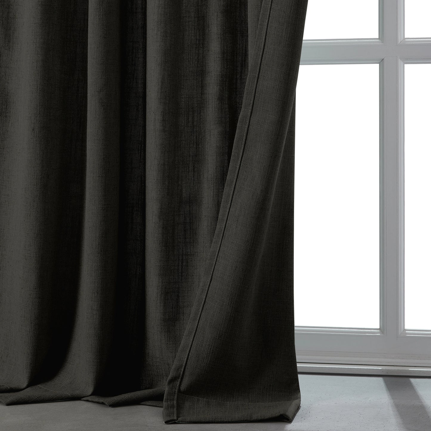 Cool dark gray linen-polyester blend lightweight curtain in front of a window.