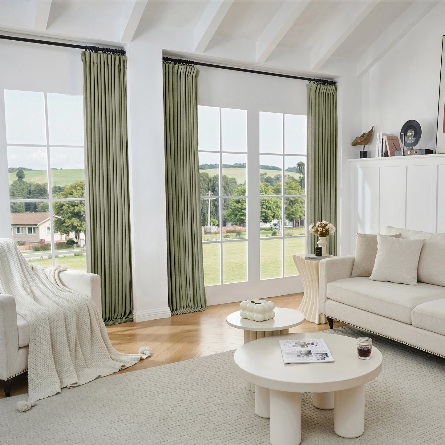 Living room with dark gray viscose, polyester, and linen mixed fabric curtain, white sofa, and tables.
