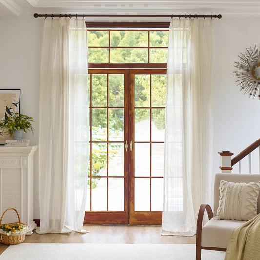 Beige farmhouse drapes with woodgrain pattern, with a chair, rug, and throw pillows in a cozy space.