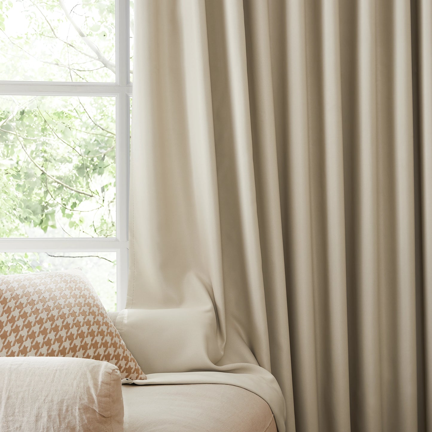 Fire retardant off-white blackout curtains, room darkening window panels behind sofa area