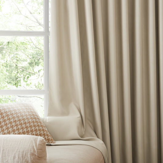 Fire retardant off-white blackout curtains, room darkening window panels behind sofa area