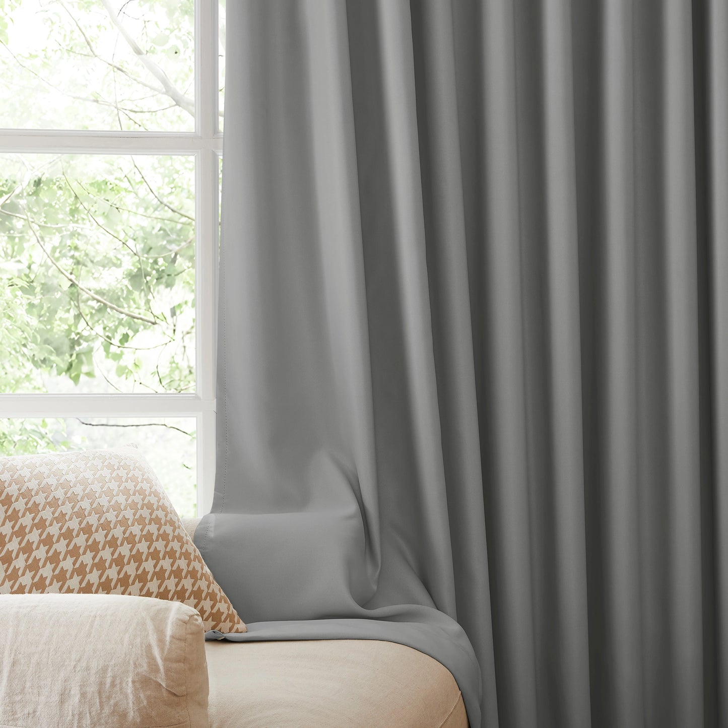 Fire retardant ash gray blackout curtains, room darkening window panels behind sofa area