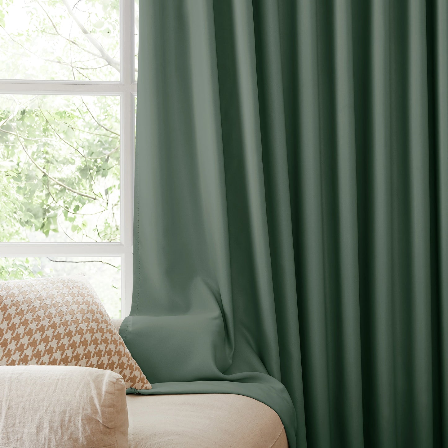 Fire retardant sage green blackout curtains, room darkening window panels behind sofa area