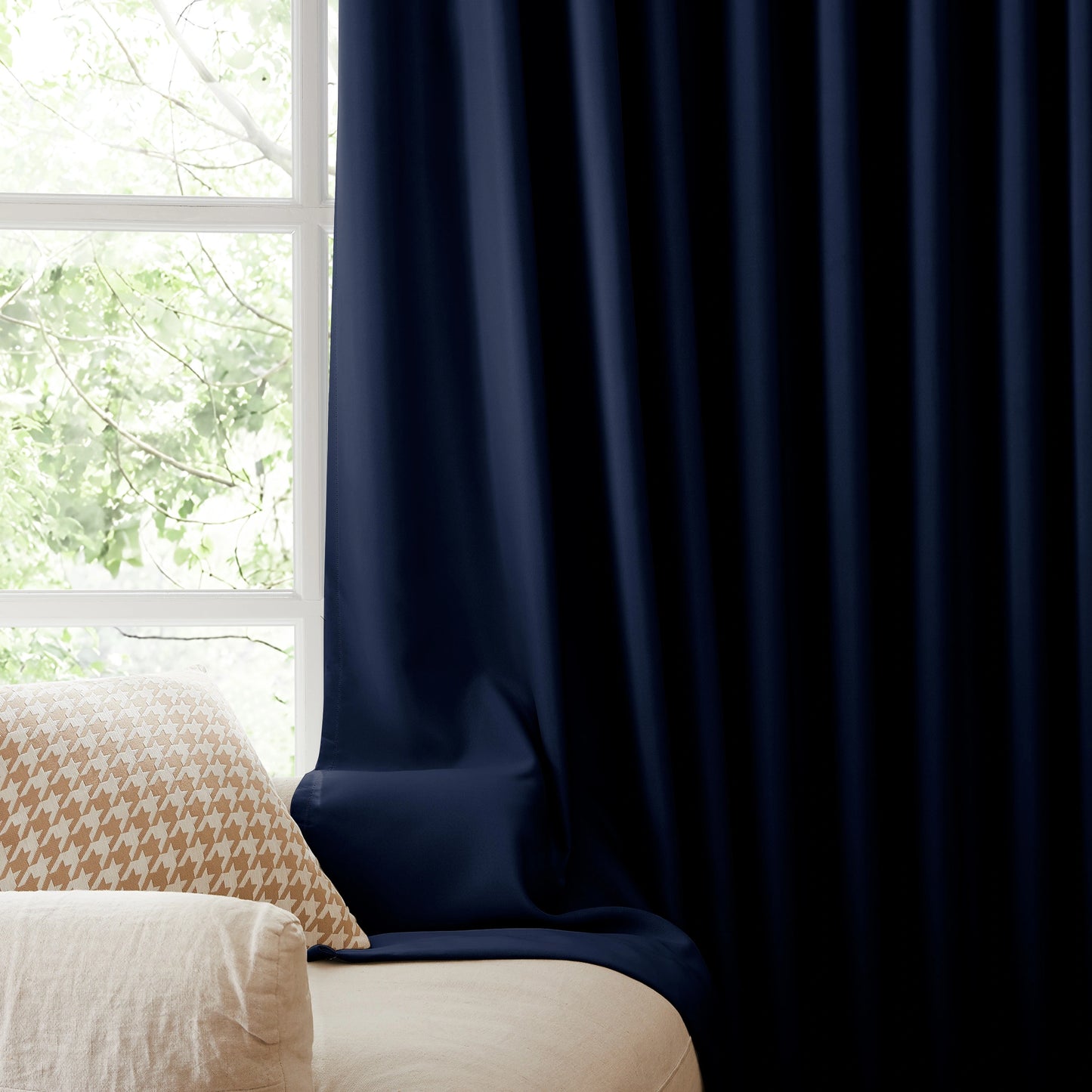 Fire retardant sapphire blue blackout curtains, room darkening window panels behind sofa area