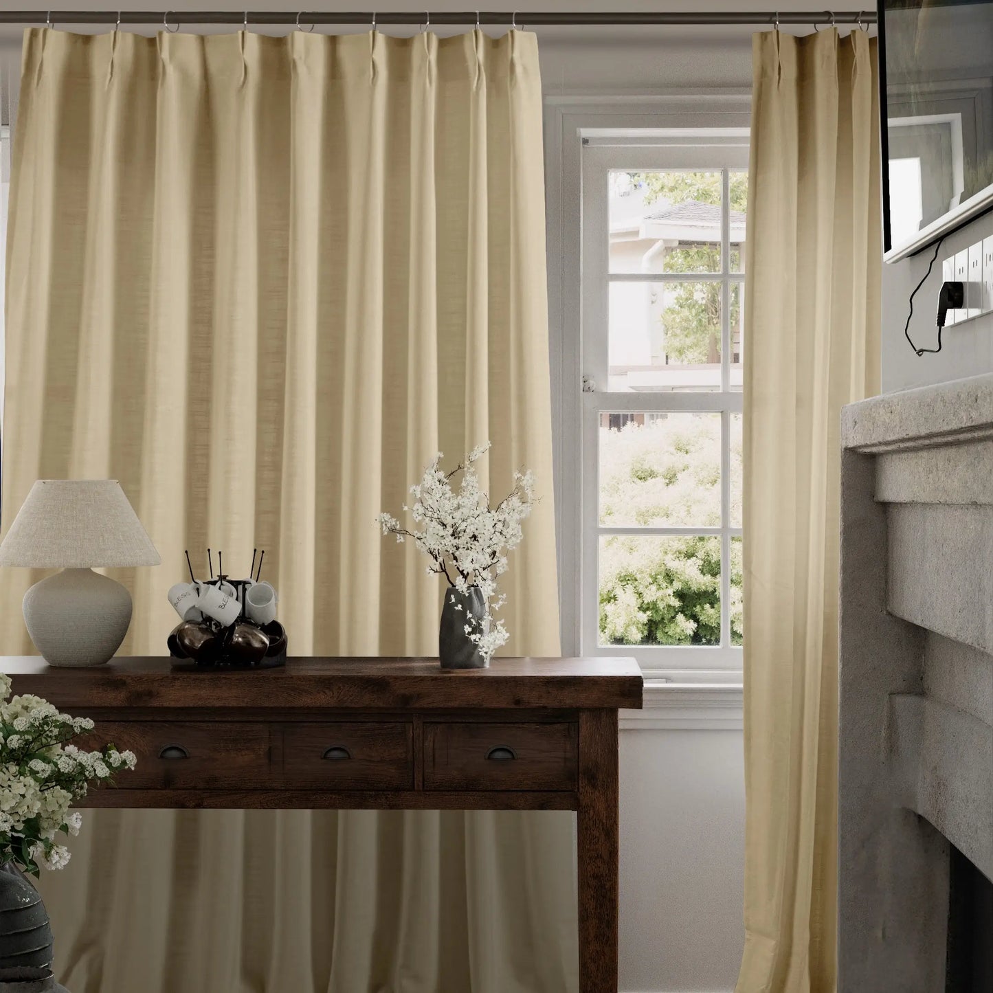 Wheat curtains hanging in a room with a wooden table and decorative items.