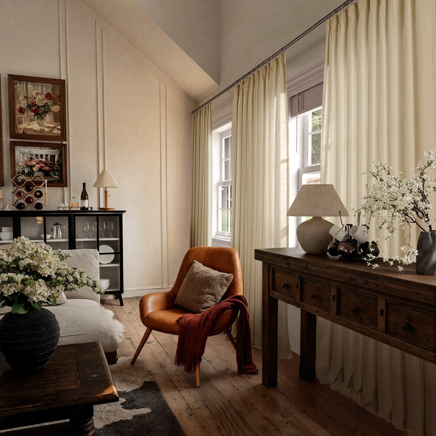 Cozy living room with a brown armchair, soft gold curtains, wooden coffee table, and decorative elements.