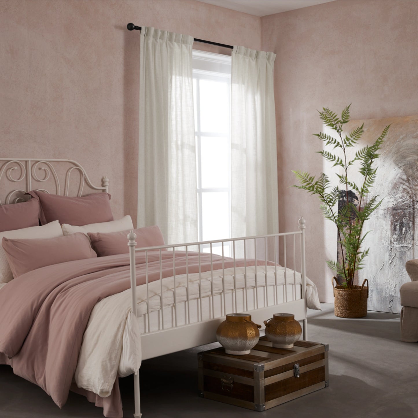 Bedroom with pink walls, white bed, decorative elements, and elegant soft hemp-colored linen-polyester mix pleated curtains.