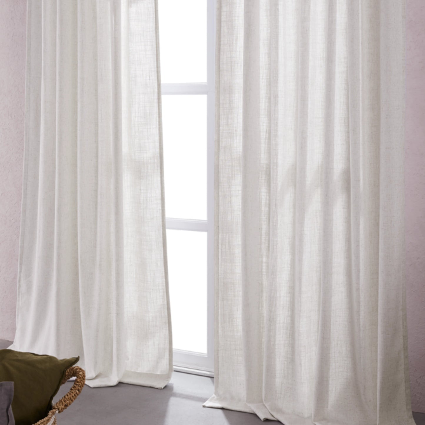 Hemp-toned linen-polyester blend curtains hanging in front of a window with a neutral background.