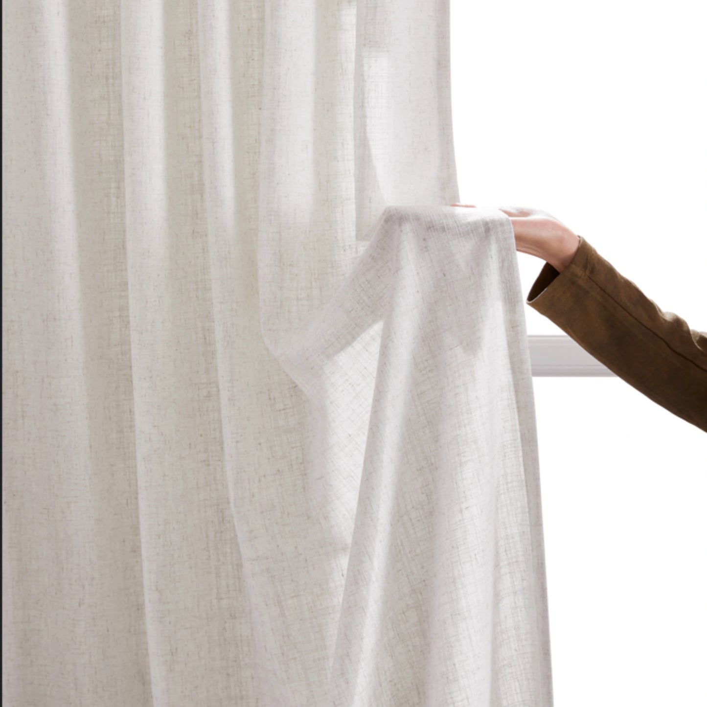 Soft hemp linen-polyester fabric window panel held by hand on a neutral background.