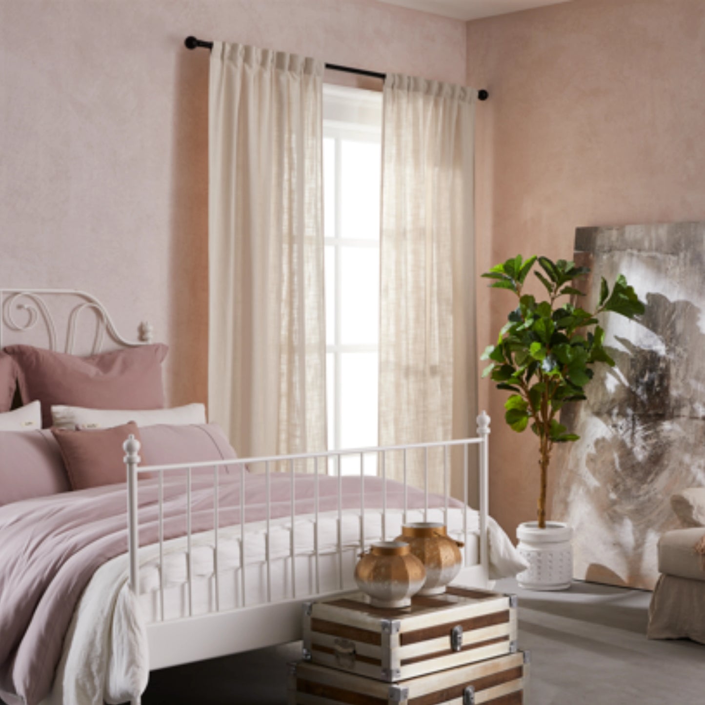 Bedroom with pink walls, white bed, decorative elements, and elegant soft ivory linen-polyester mix pleated curtains.