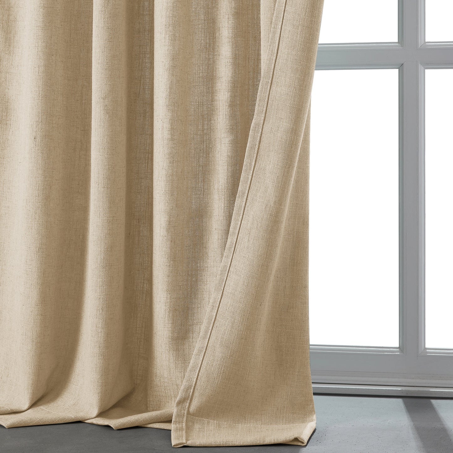 Natural khaki linen-polyester blend lightweight curtain in front of a window.