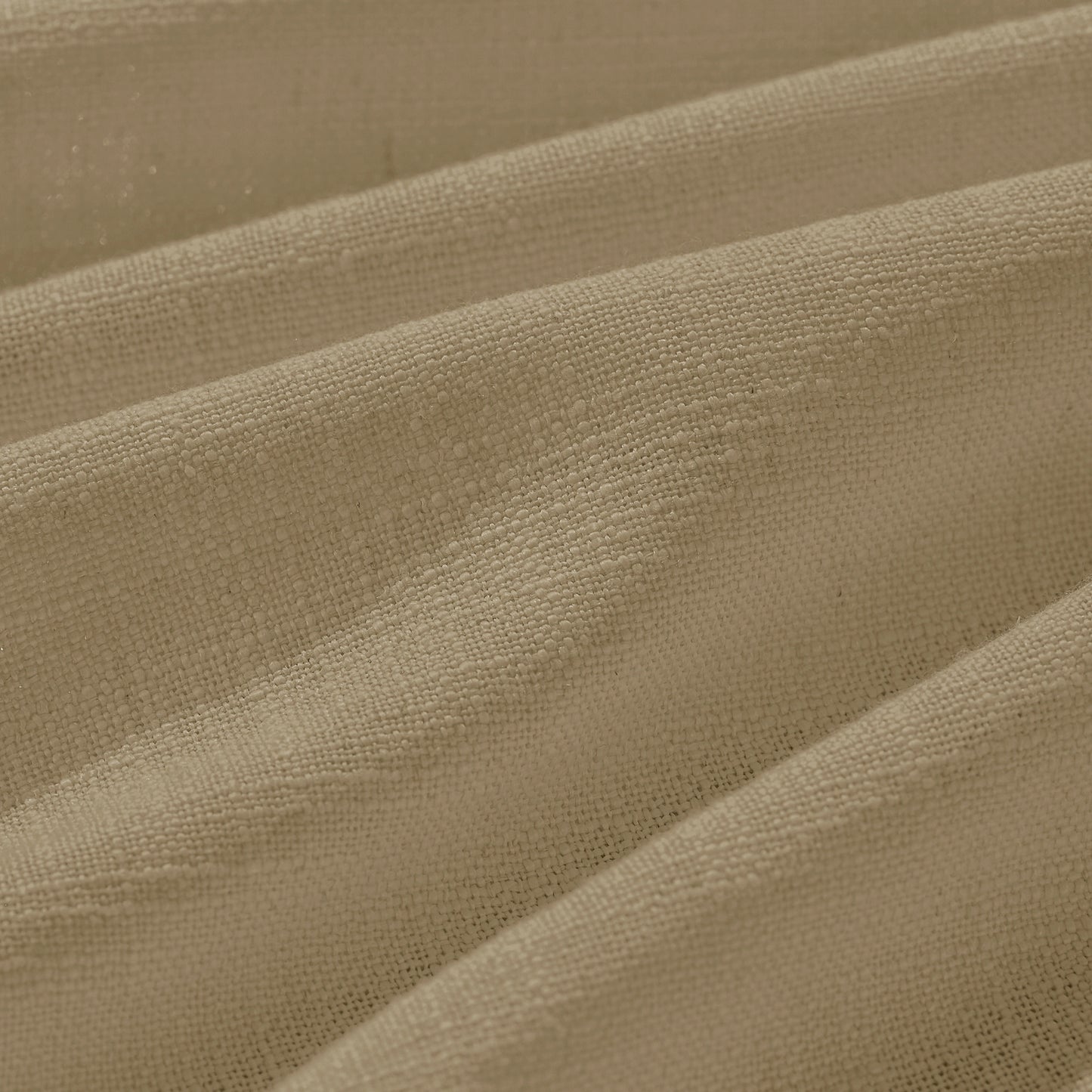 Detail of textured light khaki polyester-linen woven curtains.