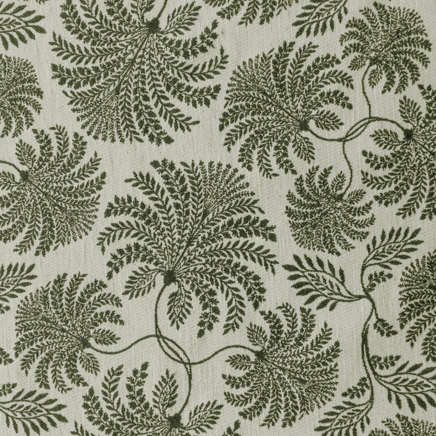 Flat lay of curtain fabric with repeating leaf patterns and a softly textured surface
