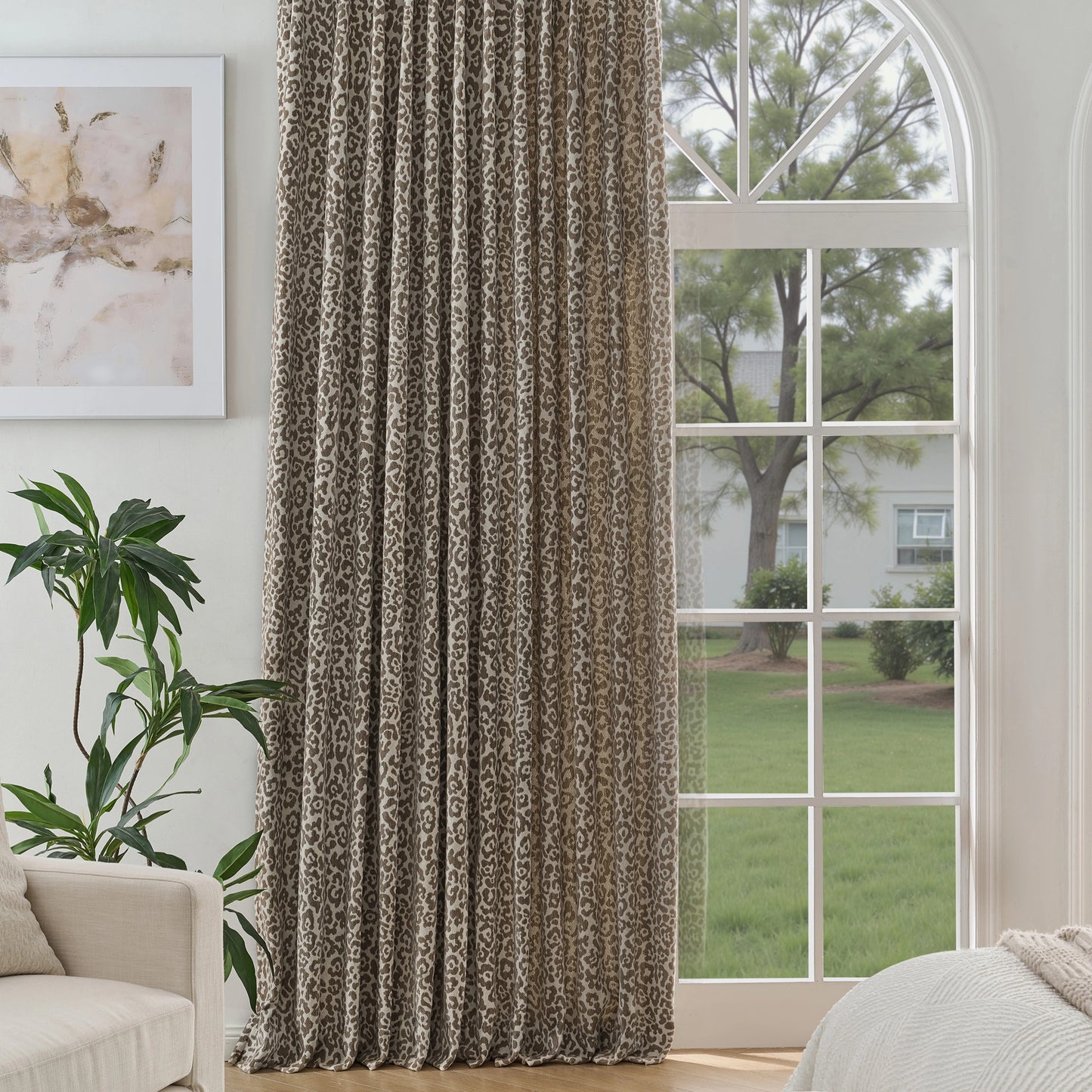 Single leopard-print floor-length curtain in front of a window, with a sofa and plants nearby.