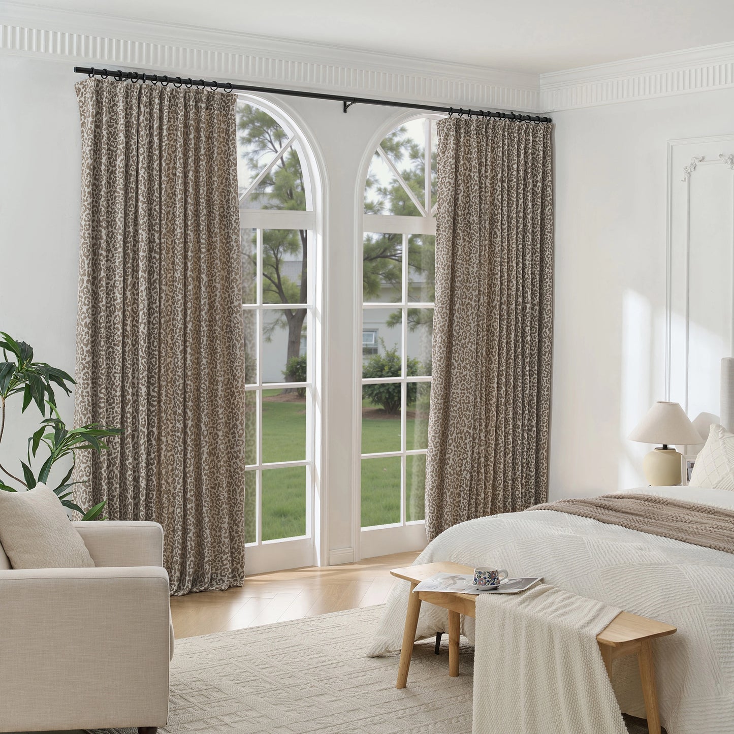 Bedroom decorated with leopard motif curtain panels, with a sofa and bed in the room.