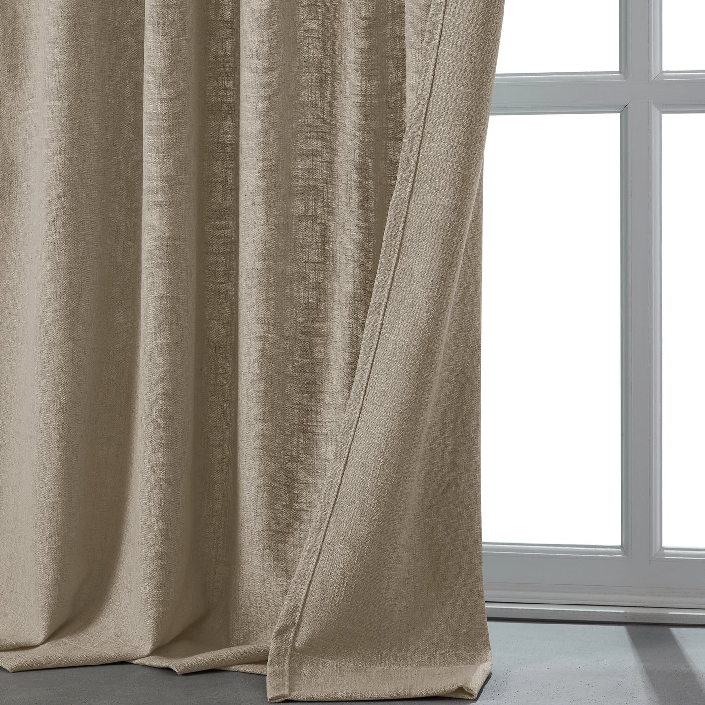 Natural light camel linen-polyester blend lightweight curtain in front of a window.