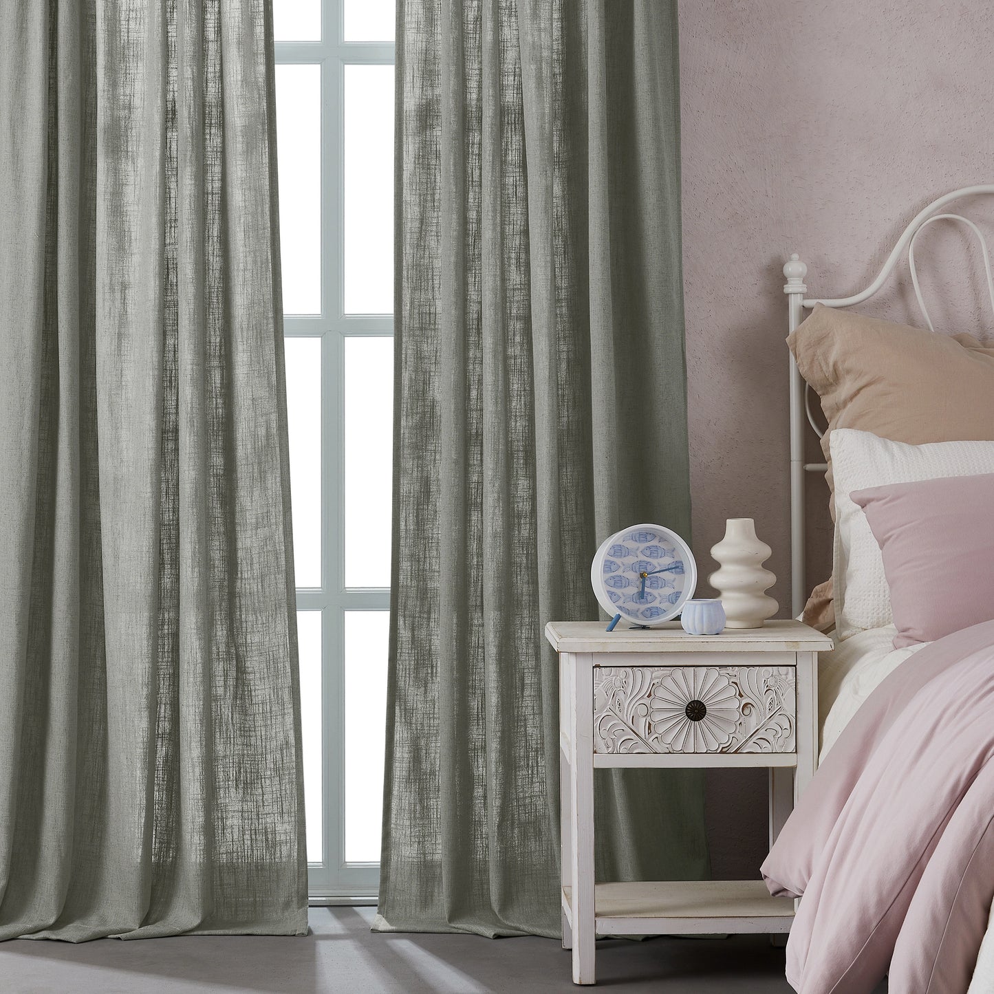 Bedroom with light gray polyester-linen combination drapery panels, a nightstand, and a bed with pink bedding.