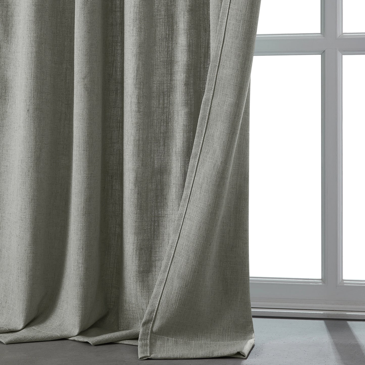 Cool light gray linen-polyester blend lightweight curtain in front of a window.
