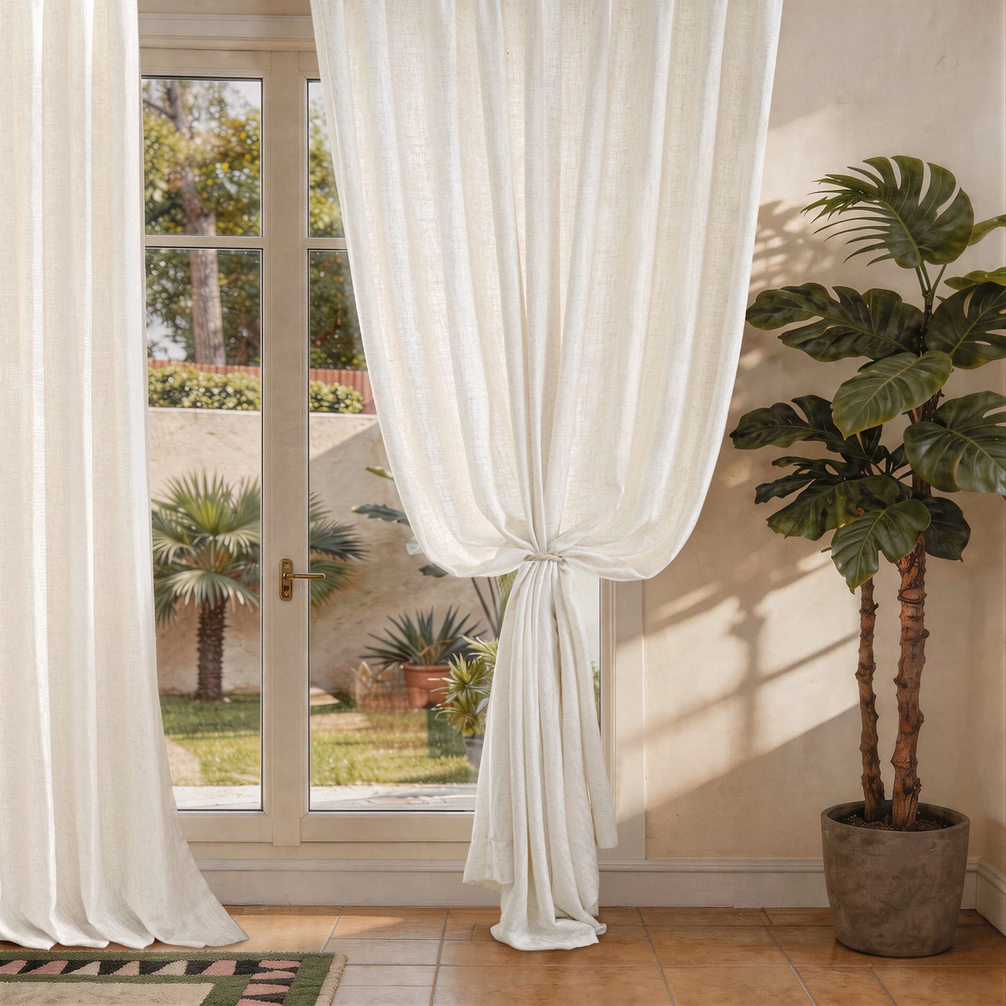 Linear patterned linen curtains tied back beside a window with soft light enhancing the vertical texture
