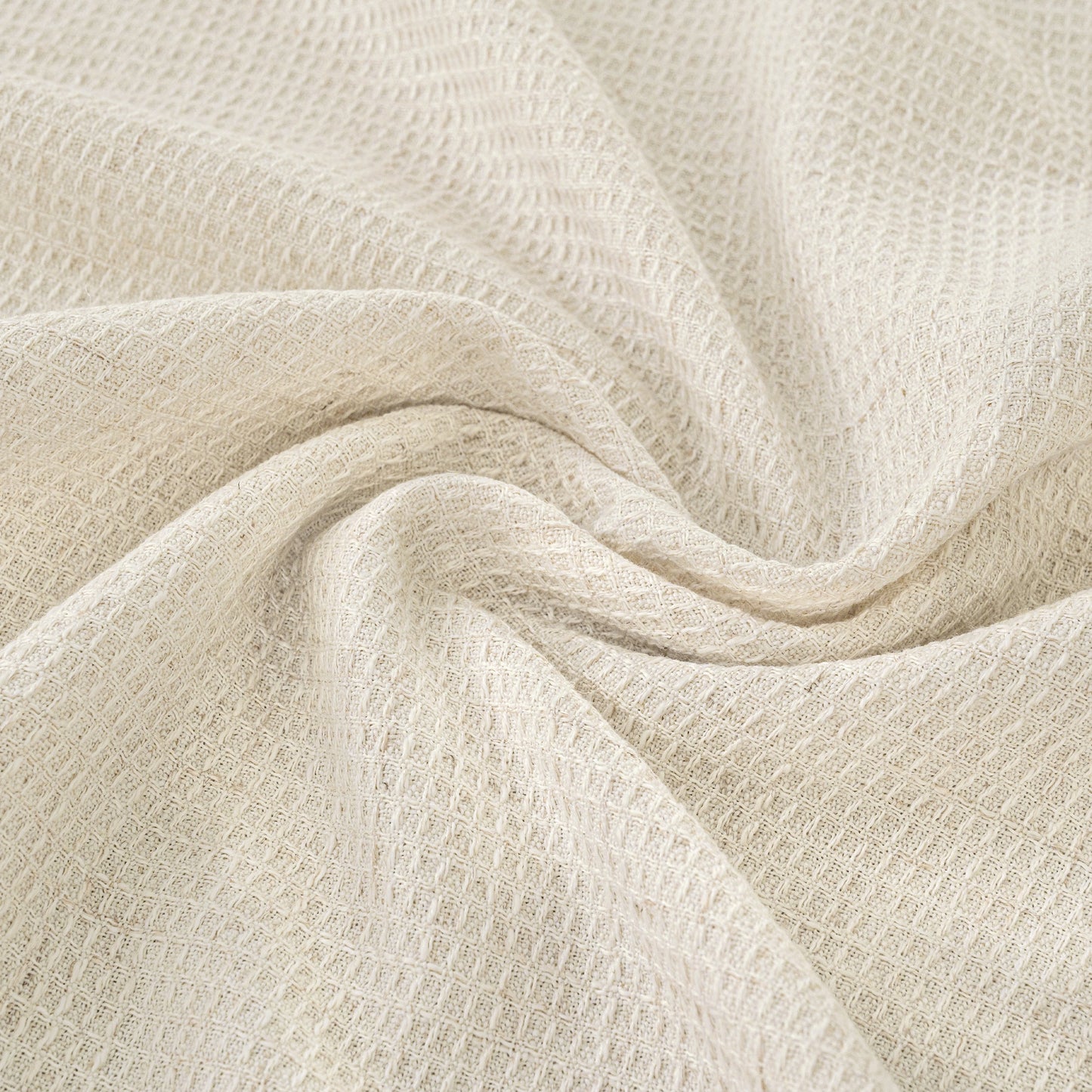 Close-up of beige textured fabric with folds