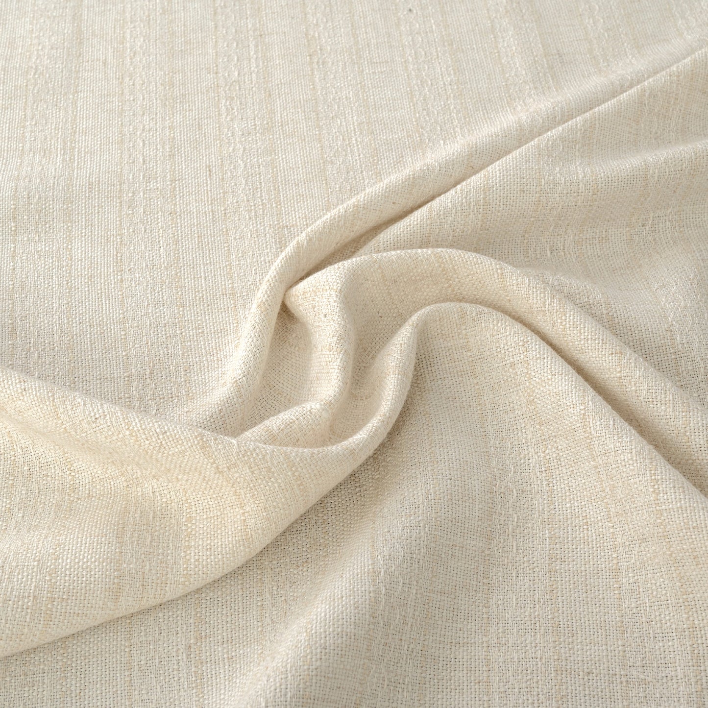 Close up of linen fabric with subtle slub texture and soft flowing folds in a natural tone