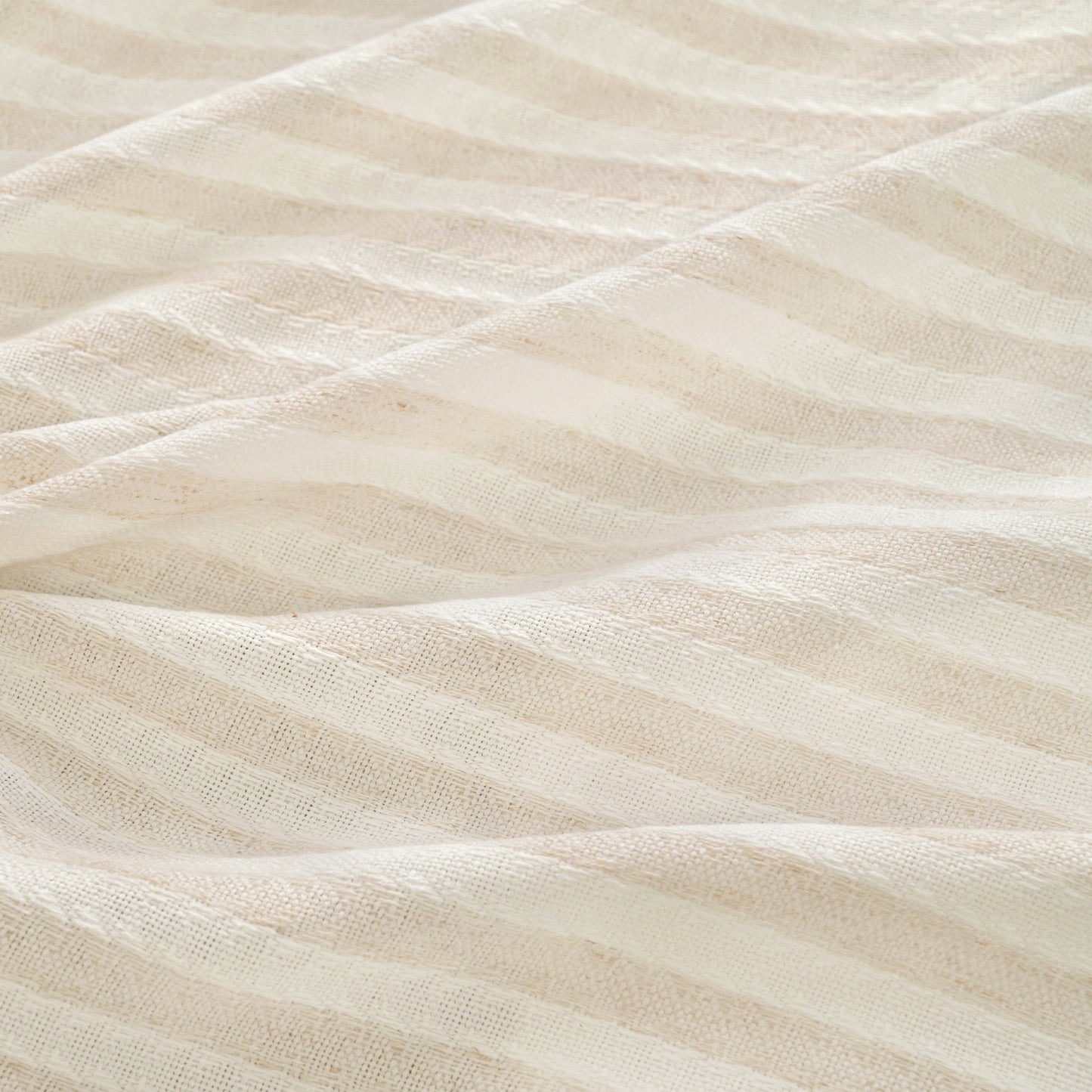 Close up of linen fabric showing vertical stripe texture and natural woven detail