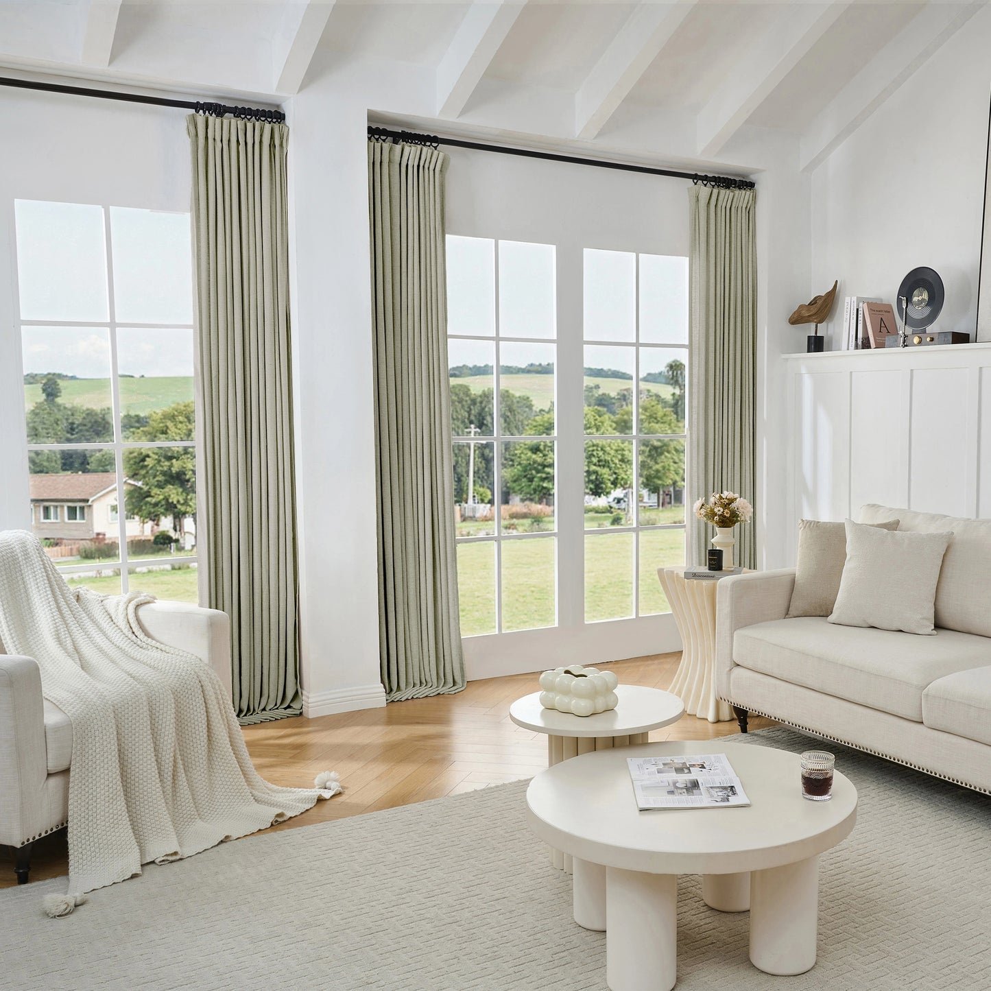 Living room with medium gray viscose, polyester, and linen mixed fabric curtain, white sofa, and tables.