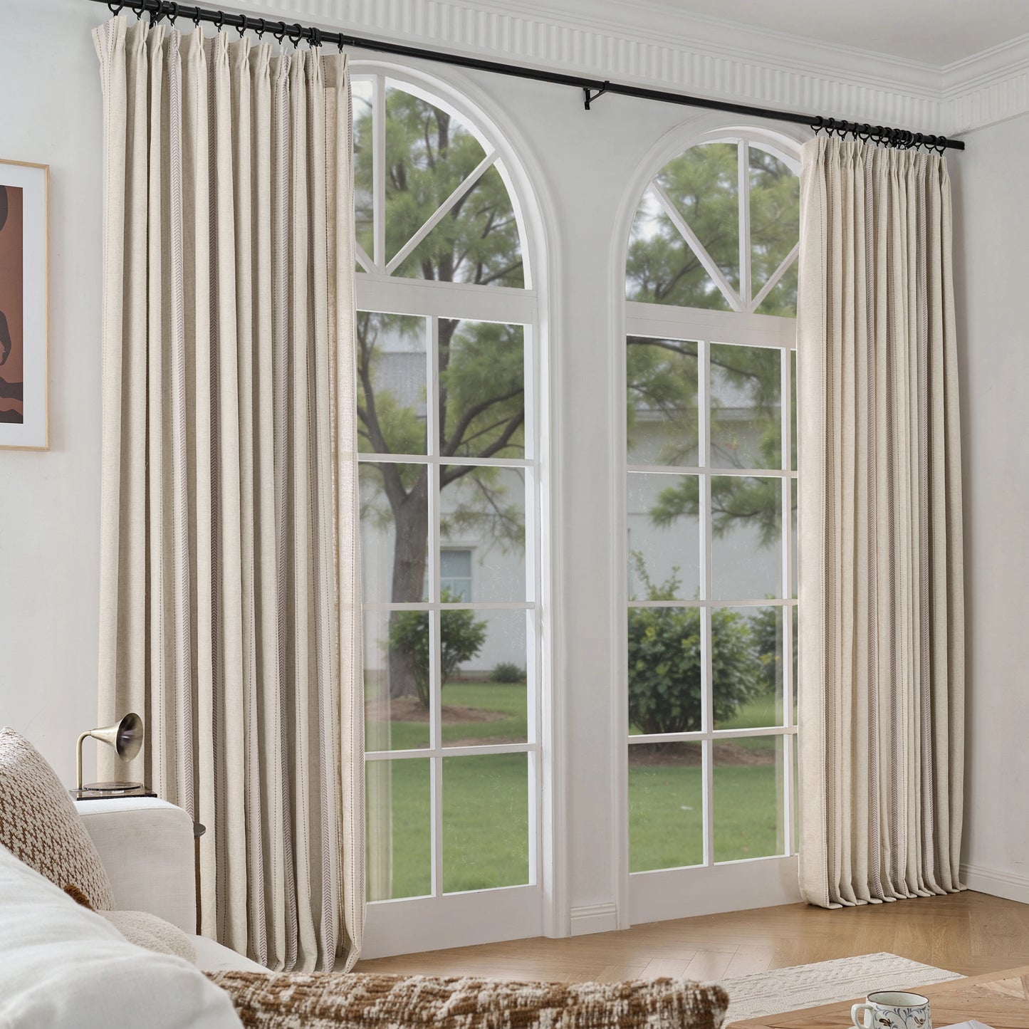 Oatmeal curtain panels in cashmere mix with polyester in a living room with a couch.