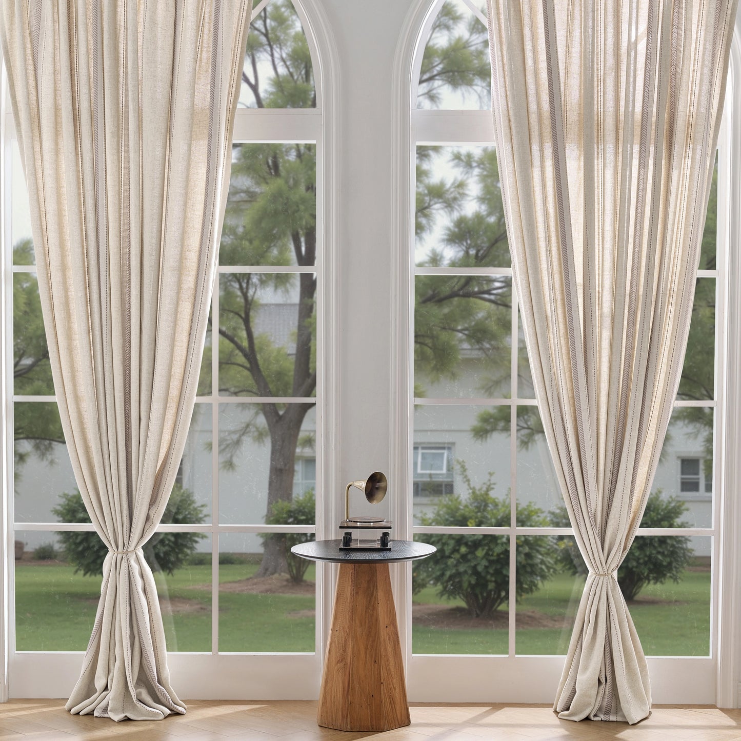 Living room with taupe-beige modern curtains in cashmere blended with polyester and large windows.