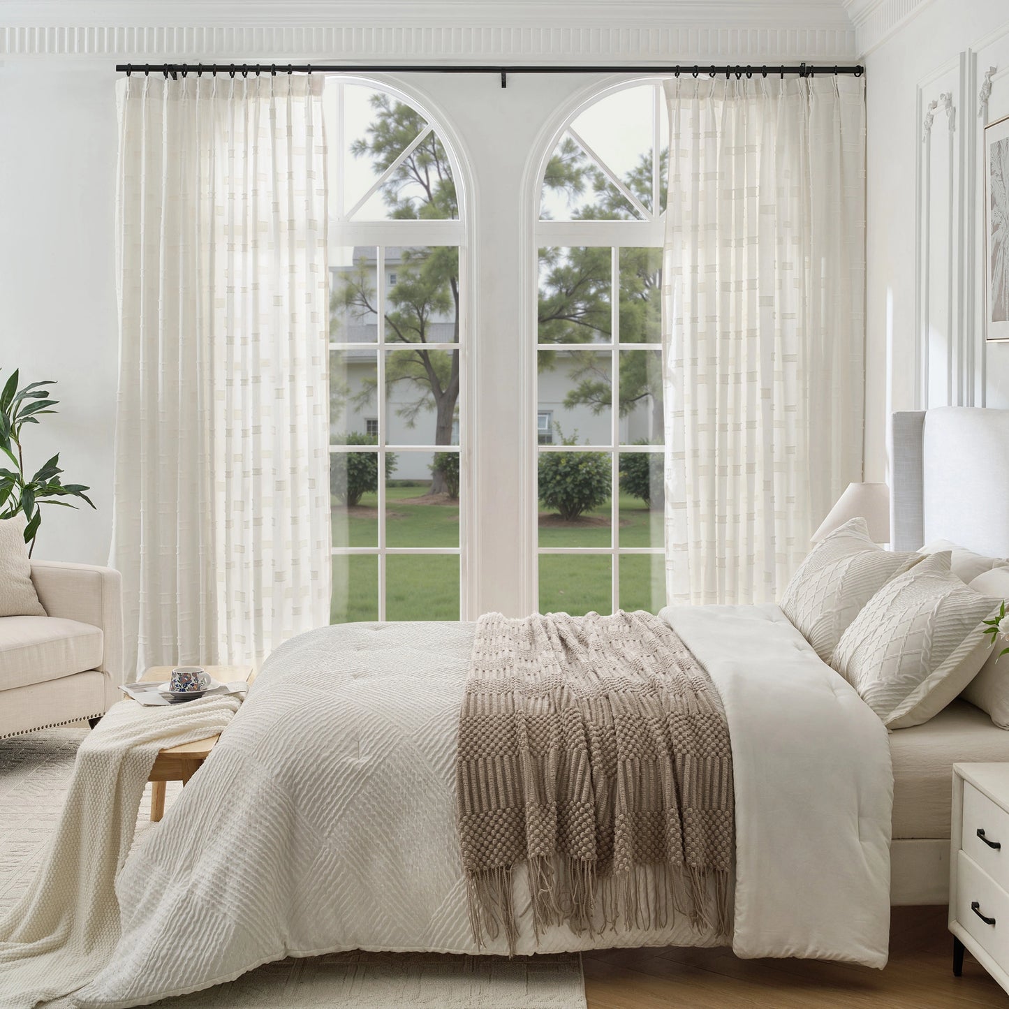 Ivory contemporary cotton-poly curtain with embossed check pattern in a bedroom with bed, sofa, and nightstand.