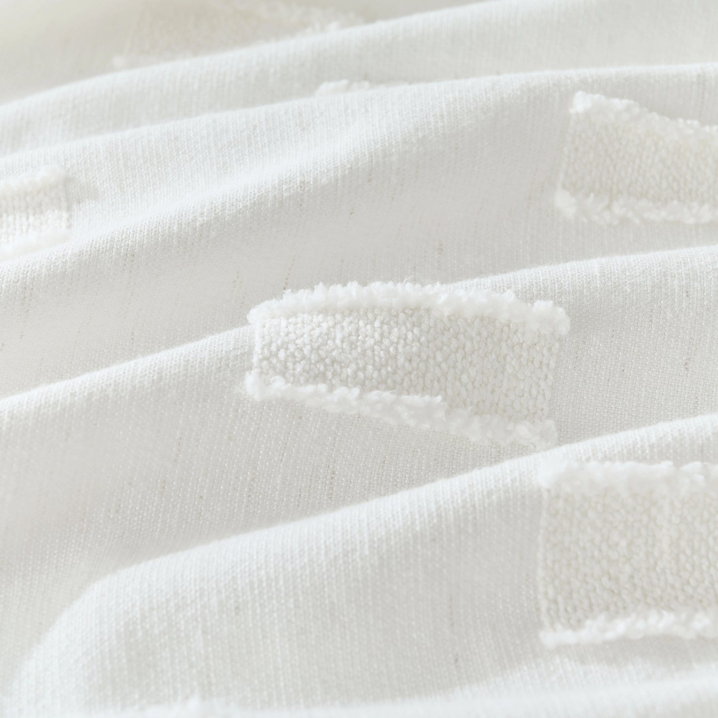 Detail of modern white curtain crafted from polyester-cotton blend, showing embossed grid pattern.