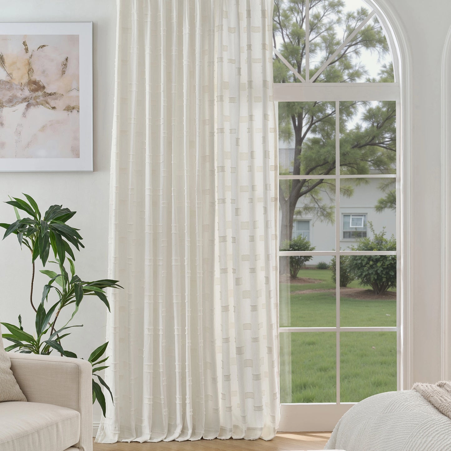 Creamy white cotton-polyester curtain panel with 3D plaid weave beside a sofa, with a window view of trees and a house.