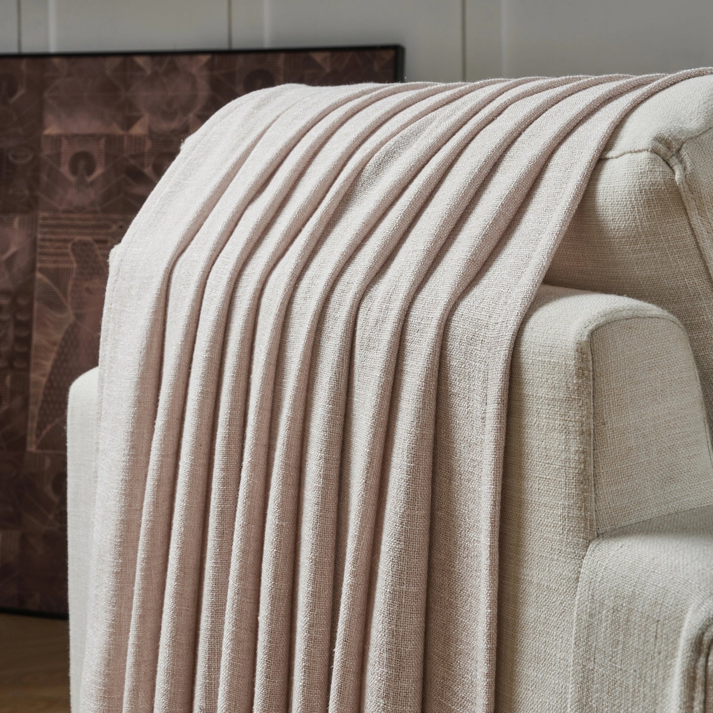Pink beige poly viscose linen curtain panel draped over a chair with a neutral background.